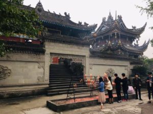 Lighting incense at the Baolun Temple